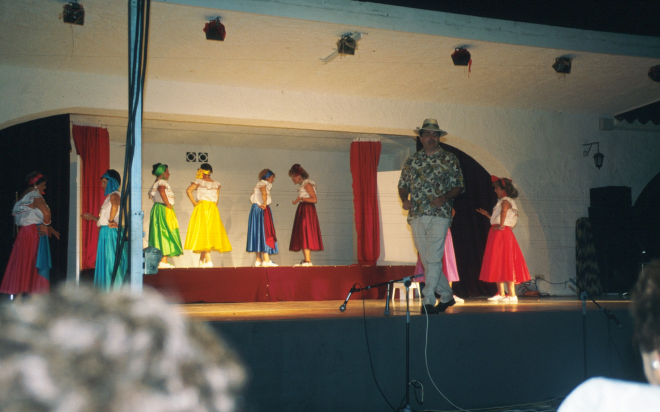Detall del festival de varietats que organitzà la coral El Gínjol per l'agost del 96 a la Pista Jardí i que fou un gran èxit en tots els aspectes. En primer terme, en Lluís Faig, presentador del festival i els actors en plena representació.