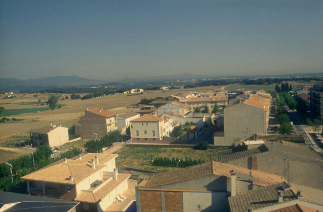 Vista parcial de Maçanet amb l'avinguda de Sant Llorenç i la masia Can Garriga al fons.
